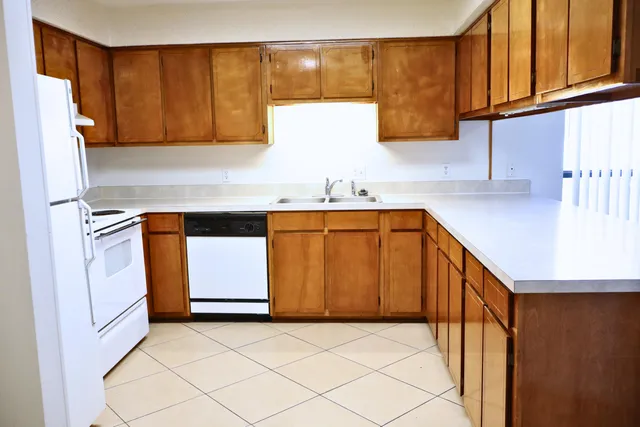 a kitchen with a sink a stove and cabinets