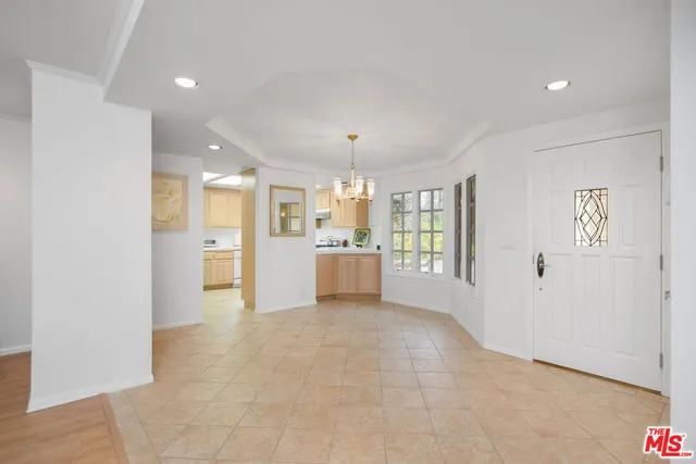 a view of an empty room with a kitchen