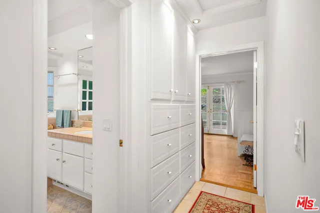 a view of an empty room and kitchen