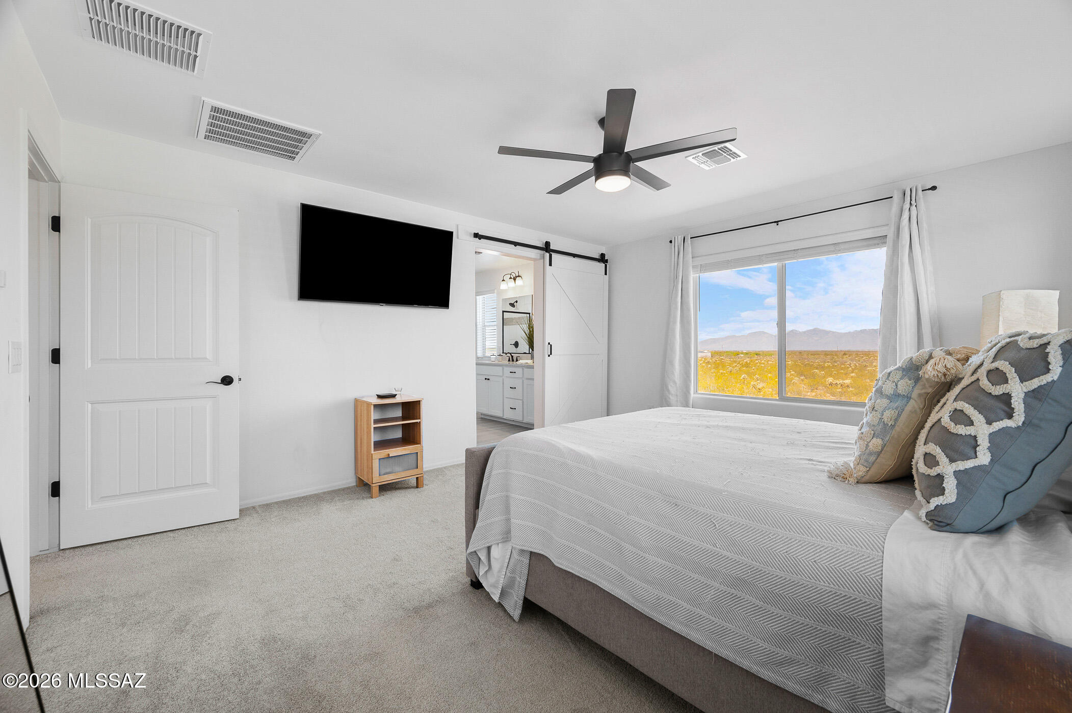 12092 East Ryscott Circle Vail, AZ 85641 - Photo 29 of 49 a bedroom with a bed and a flat tv screen on dresser