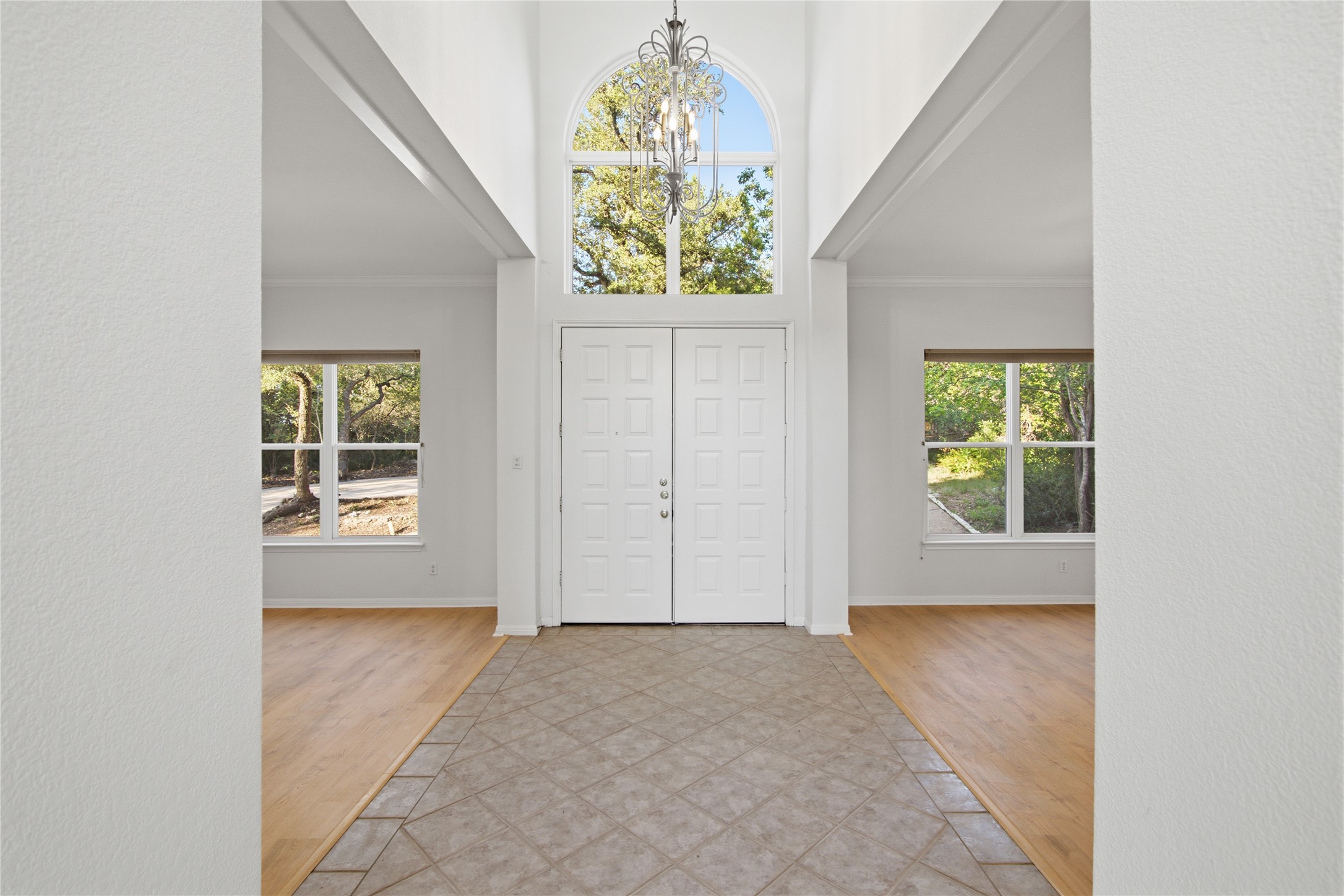 8204 Texas Plume Road Austin, TX 78759 - Photo 13 of 40 Grand double doors welcome you into a soaring foyer, illuminated by an arched window and elegant chandelier.