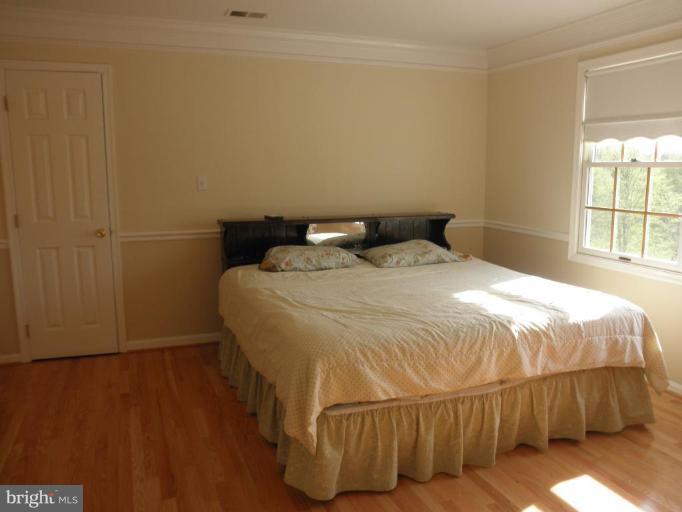 3251 Old Jones Road Dunkirk, MD 20754 - Photo 8 of 24 LARGE BEDROOM WITH WOOD FLOORING