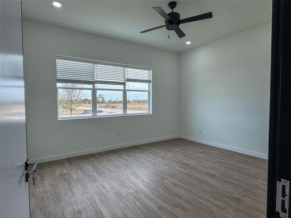 440 Lucy Road Greenville, TX 75402 - Photo 11 of 19 a view of an empty room with a window and wooden floor