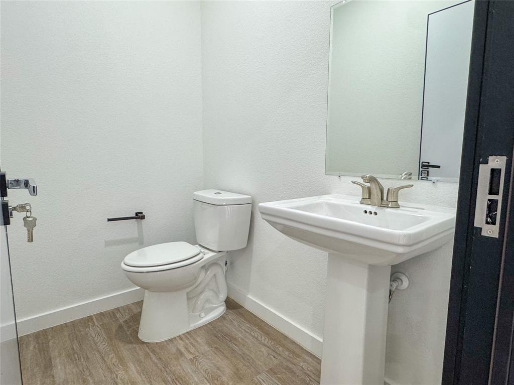 440 Lucy Road Greenville, TX 75402 - Photo 12 of 19 a bathroom with a sink and a toilet