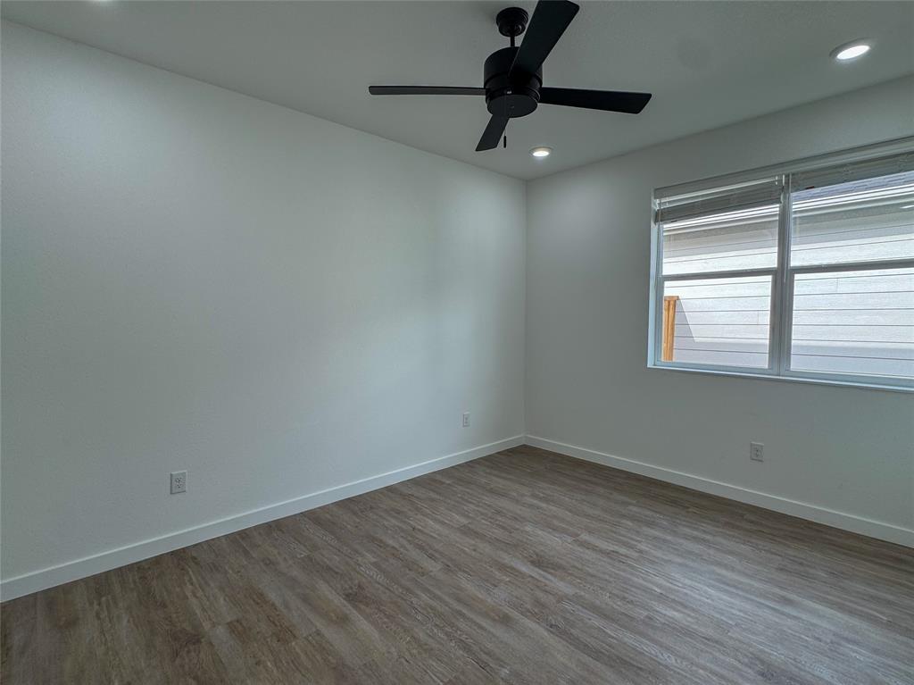 440 Lucy Road Greenville, TX 75402 - Photo 13 of 19 wooden floor in an empty room with a window