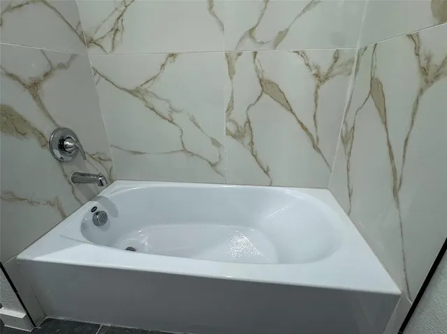 a white bath tub sitting in a bathroom