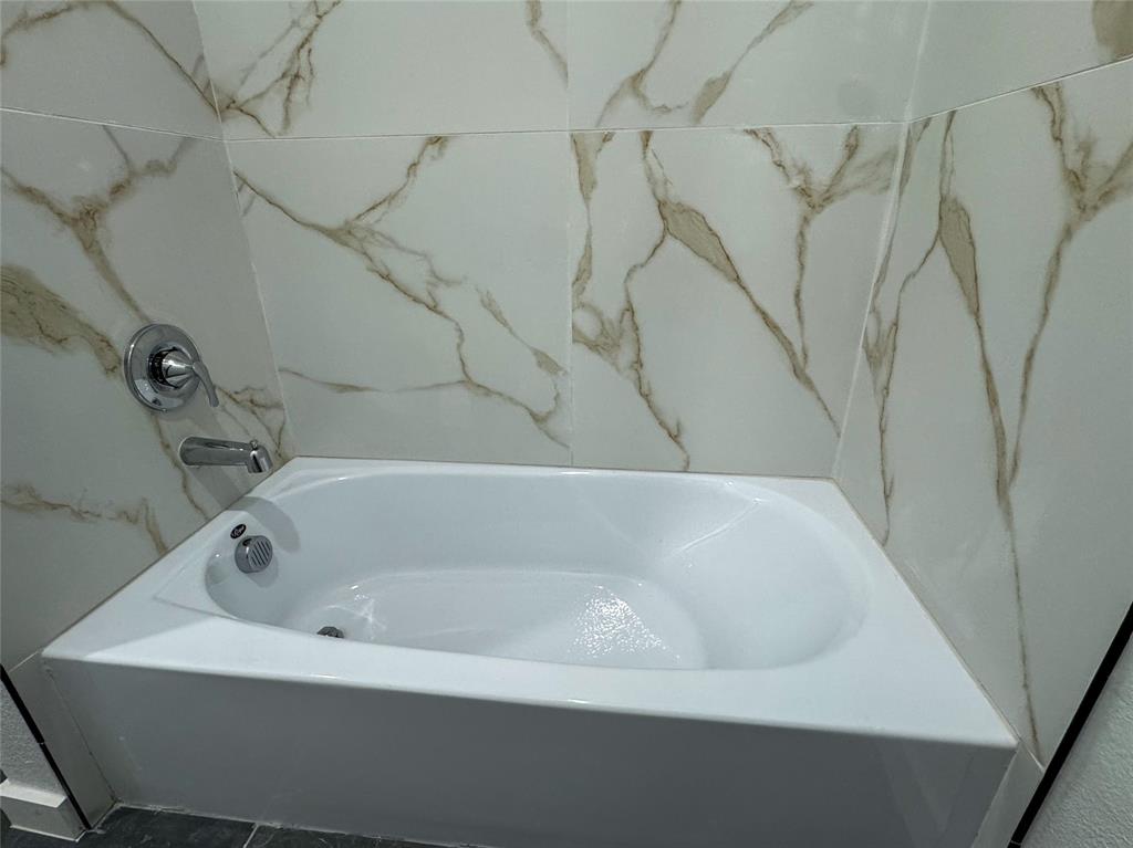 440 Lucy Road Greenville, TX 75402 - Photo 15 of 19 a white bath tub sitting in a bathroom