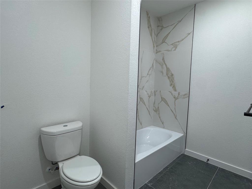 440 Lucy Road Greenville, TX 75402 - Photo 16 of 19 a bathroom with a toilet and a shower