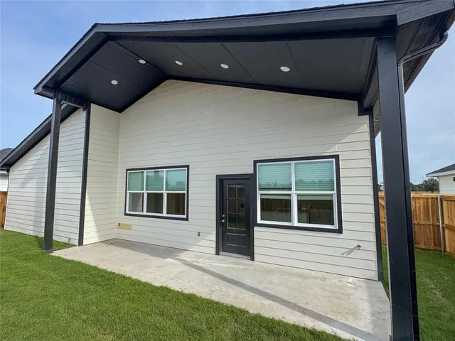 a black and white building with a large window