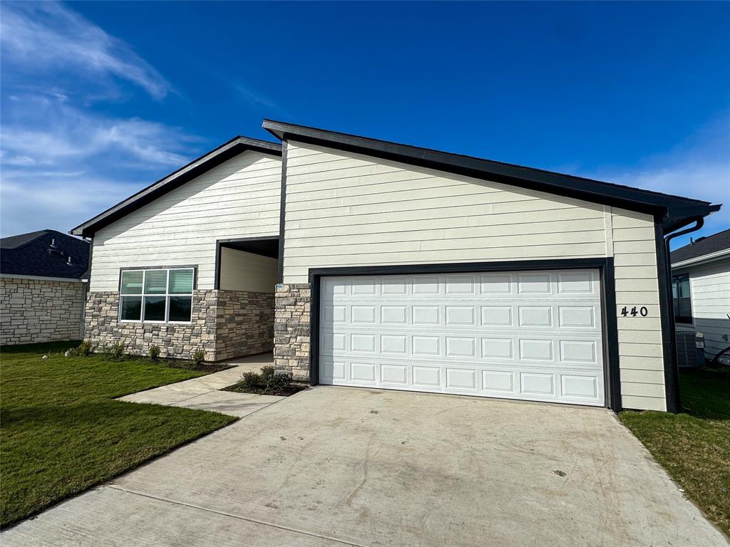 440 Lucy Road Greenville, TX 75402 - Photo 3 of 19 a front view of a house with a yard and garage