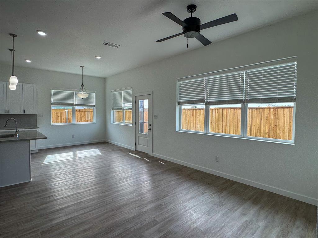 440 Lucy Road Greenville, TX 75402 - Photo 7 of 19 a view of an empty room with window and wooden floor