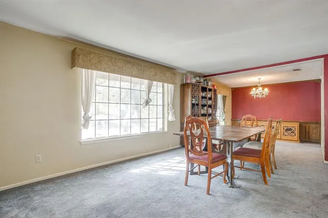 a view of a dining room with furniture and a window