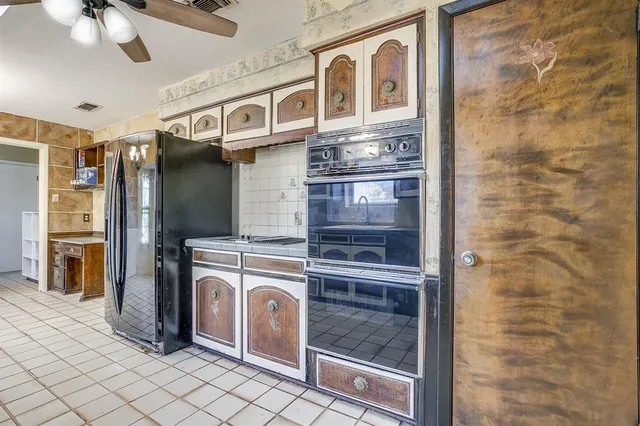 a kitchen with stainless steel appliances granite countertop a refrigerator and a stove