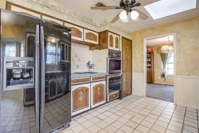 a kitchen with stainless steel appliances granite countertop a refrigerator and a sink