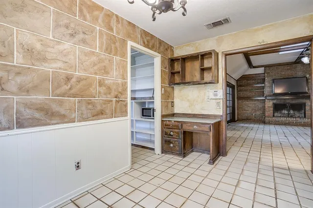 a kitchen with stainless steel appliances kitchen island granite countertop a refrigerator and stove top oven