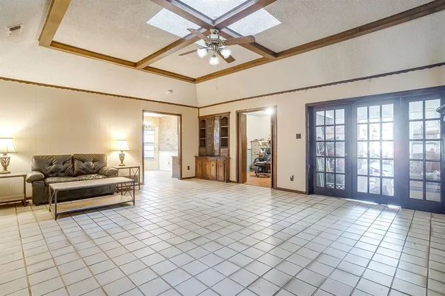 a living room with a large couches and chandelier