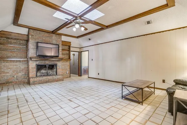 a view of an empty room with a fireplace