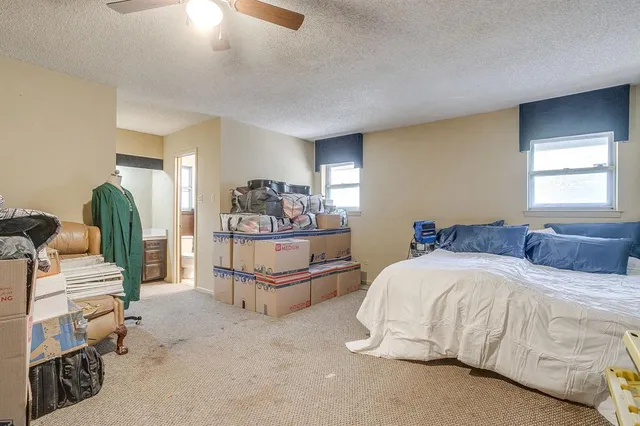 a spacious bedroom with a bed and a couch