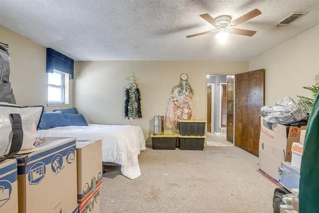 a bed room with a bed and a chandelier