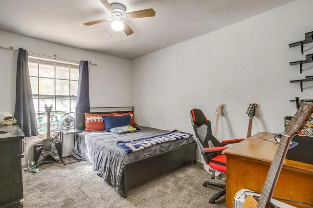 a bedroom with bed and a chandelier