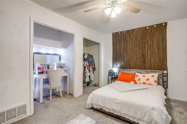 a bedroom with a bed and a walk in closet