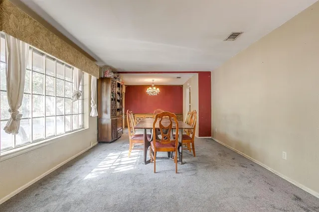 a view of a room with a large window and chair