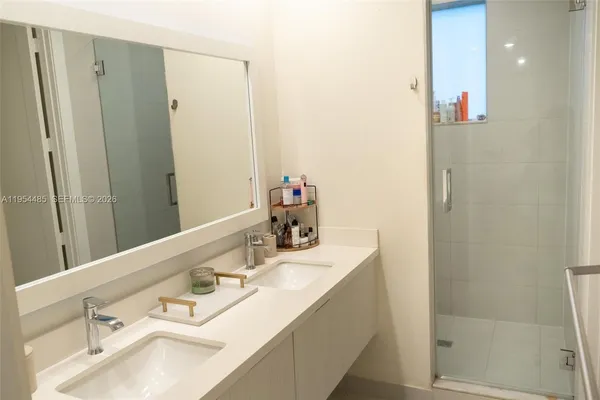 a bathroom with a sink vanity tub and shower