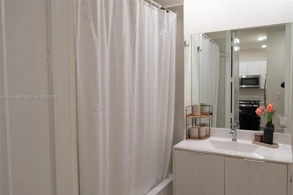 a bathroom with a sink a vanity and a mirror