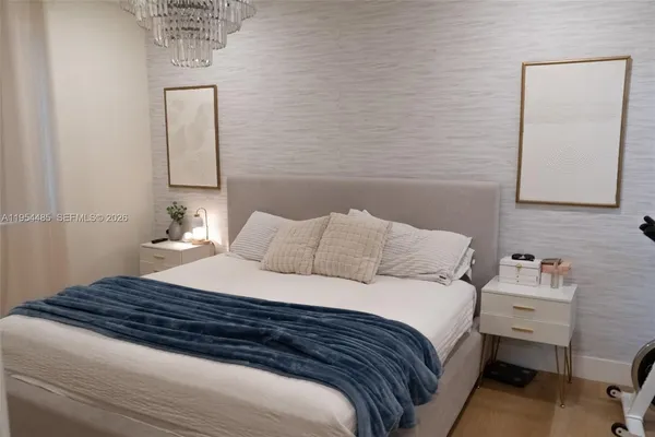 a bedroom with a bed and a mirror