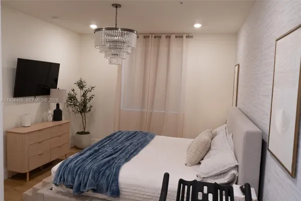a bedroom with a bed and flat screen tv