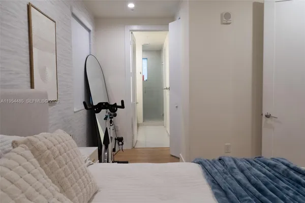 a bedroom with a bed and a mirror