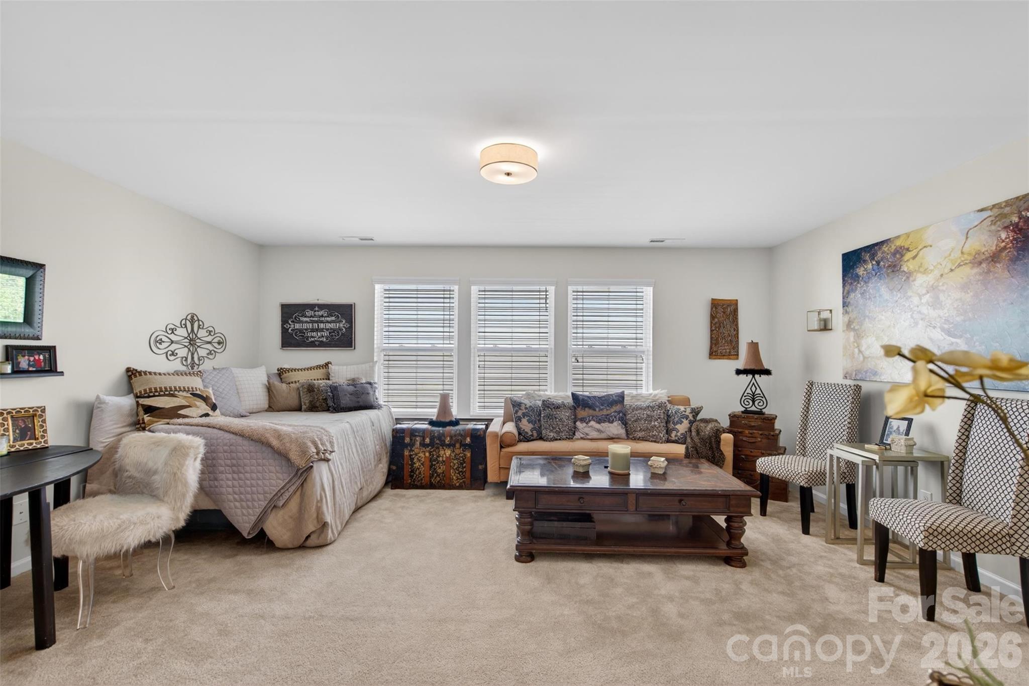 6038 Durango Way Denver, NC 28037 - Photo 17 of 20 a spacious bedroom with bed and a couch