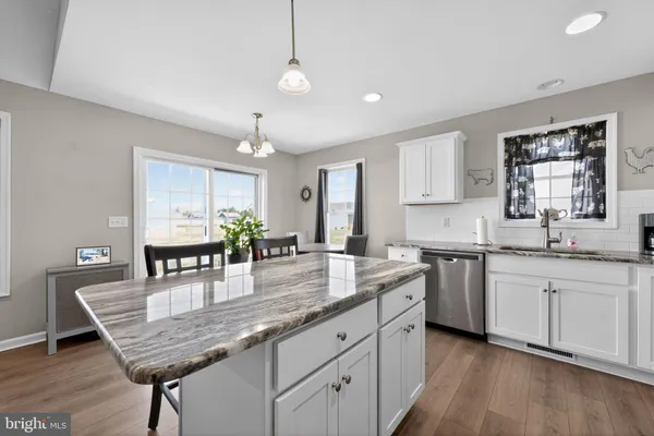 a kitchen with counter space cabinets and wooden floor