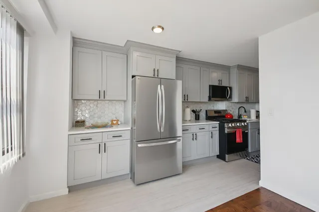 a kitchen with a refrigerator and cabinets