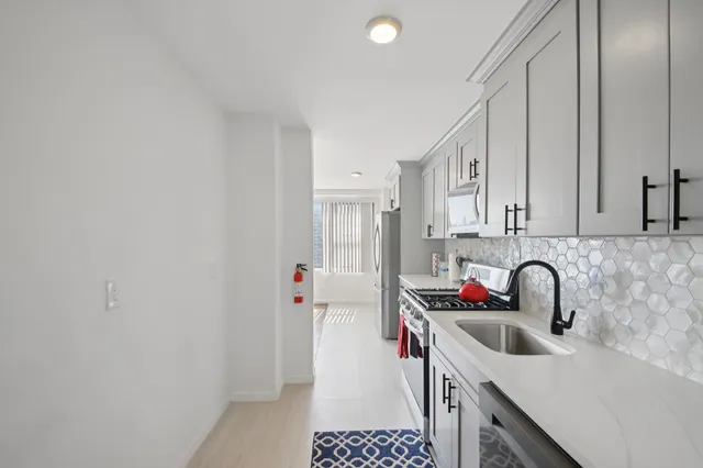 a kitchen with a sink and cabinets