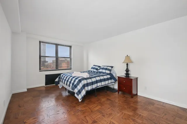 a bedroom with a bed and window