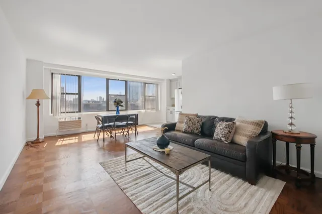 a living room with furniture and a rug