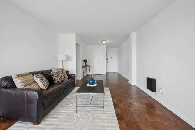 a living room with furniture and kitchen view