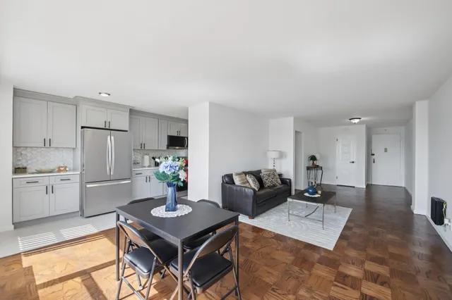 a dining room with furniture and a floor to ceiling window