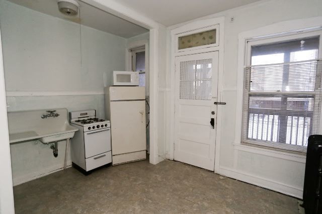 1921 West Winnemac Avenue, Unit 1 Chicago, IL 60640 - Photo 2 of 14 an empty room with windows