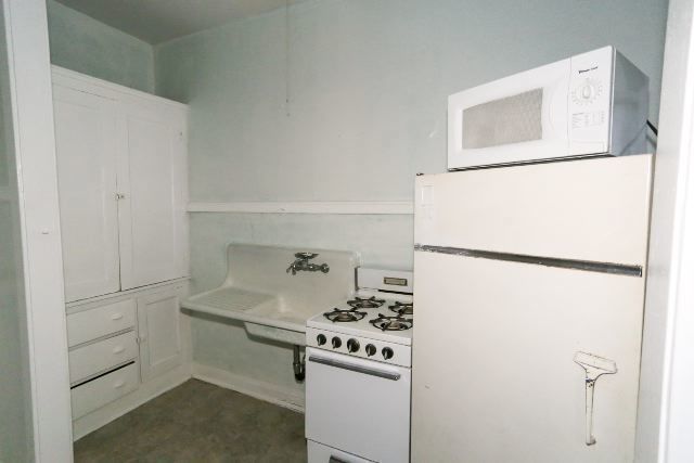 1921 West Winnemac Avenue, Unit 1 Chicago, IL 60640 - Photo 6 of 14 a kitchen with a refrigerator and a stove