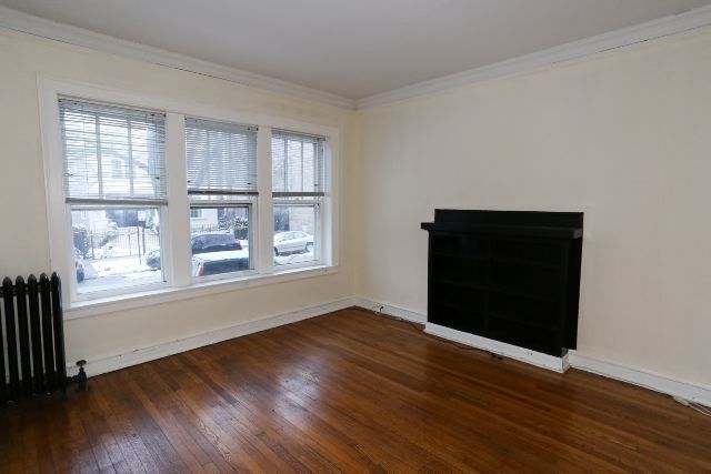 1921 West Winnemac Avenue, Unit 1 Chicago, IL 60640 - Photo 7 of 14 a view of an empty room with wooden floor and a window