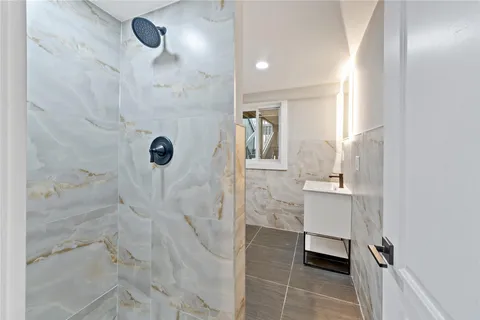 a bathroom with a shower and a sink
