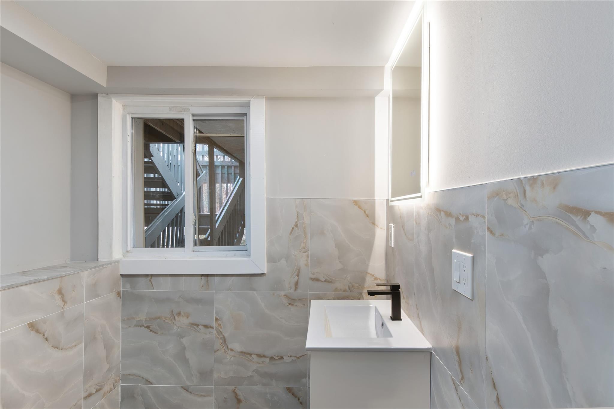 96 Fairmont Road Mahopac, NY 10541 - Photo 22 of 29 a bathroom with a sink a mirror and window