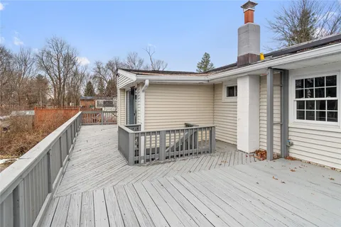 a view of a house with wooden deck