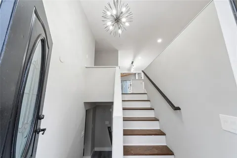 a view of entryway and hall with wooden floor