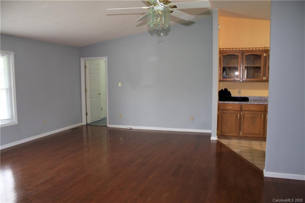 1095 Lawrence Road Clover, SC 29710 - Photo 2 of 20 a view of an empty room with a window and wooden floor
