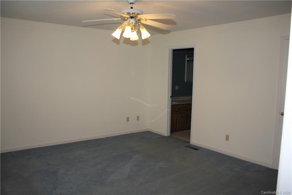 1095 Lawrence Road Clover, SC 29710 - Photo 15 of 20 an empty room with a fan and a chandelier fan
