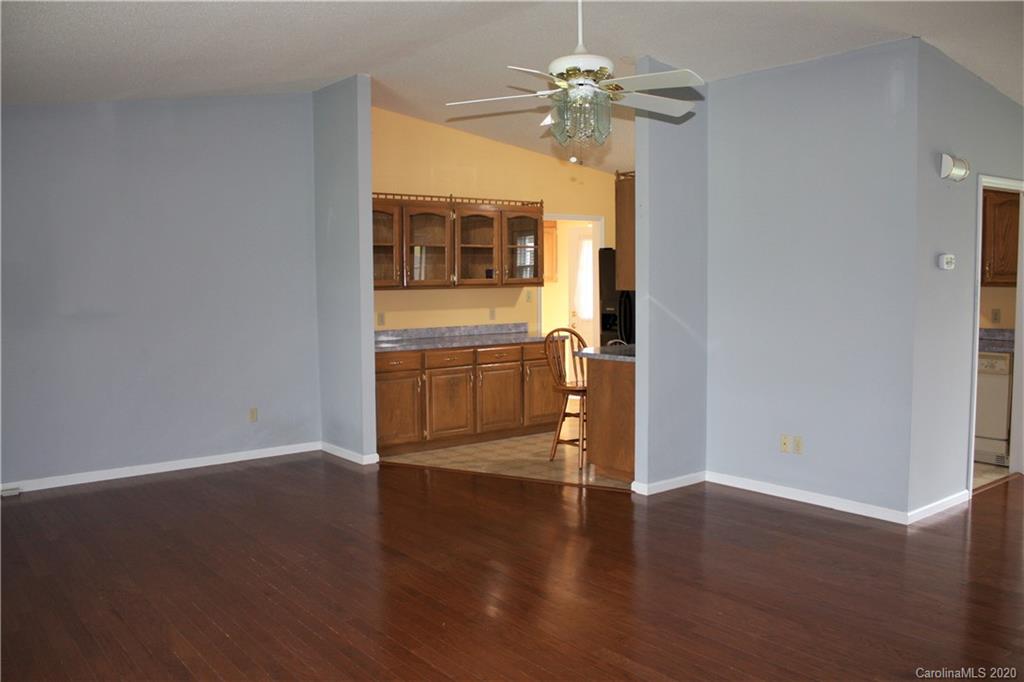 1095 Lawrence Road Clover, SC 29710 - Photo 4 of 20 a view of an empty room with a window and wooden floor