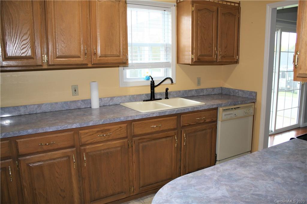 1095 Lawrence Road Clover, SC 29710 - Photo 7 of 20 a kitchen with a sink cabinets and window